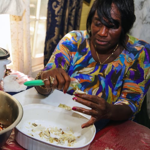 With practiced hands, chef and author Sallie Ann Robinson swiftly picks the sweet, tender crab meat from the legs and shells, showcasing her expertise and the efficiency honed by generations of island cooking in a photo from 2024. (Adriana Iris Boatwright for The Atlanta Journal-Constitution)