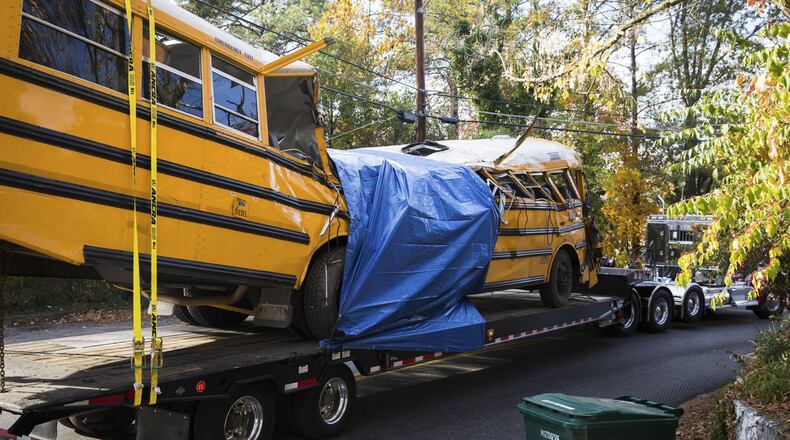 A school bus that crashed a day earlier is removed from the accident site in Chattanooga, Tenn., Nov. 22, 2016. A school bus driver was speeding and swerving when he crashed the bus on Monday, killing at least five students, the authorities said, in one of the deadliest school bus accidents in recent years. (Kevin D. Liles/The New York Times)