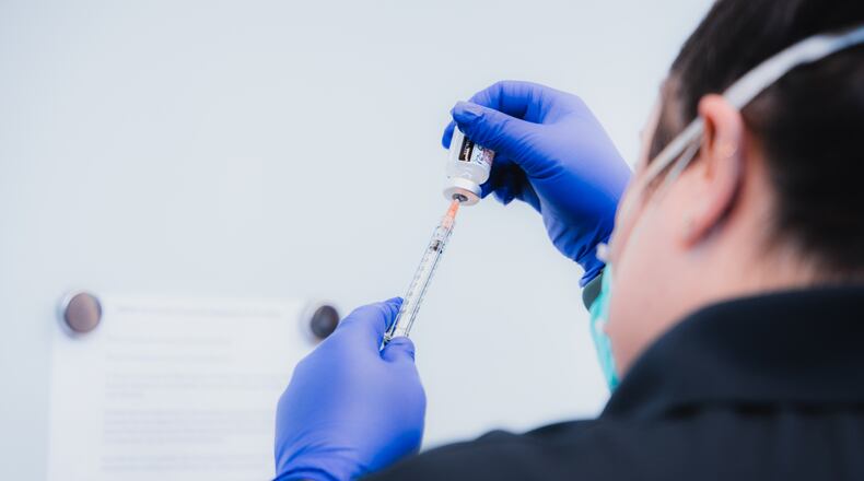 A healthcare worker prepares to administer the COVID-19 vaccine to Marietta City Schools employees. Credit: Natalie Roush/Marietta City Schools