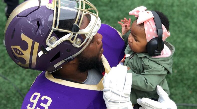 Former Georgia Tech defensive lineman T.J. Barnes with his daughter Zuri while playing for the Atlanta Legends of the defunct Alliance of American Football. (Photo courtesy T.J. Barnes)