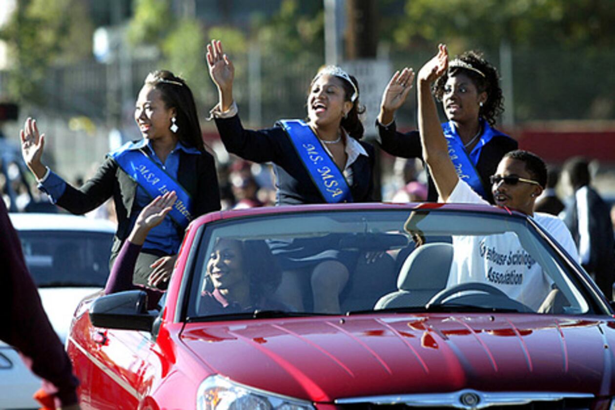 Members of the Morehouse College Sociological Association wave to spectators as they drive down Joseph E. Lowery Boulevard during the Morehouse Homecoming Parade. (From left) Melanie Harris, first attendant, Gimel Rogers, queen, and Qivon Annan, second attendant enjoy the college's homecoming. (Jason Getz/AJC FILE)