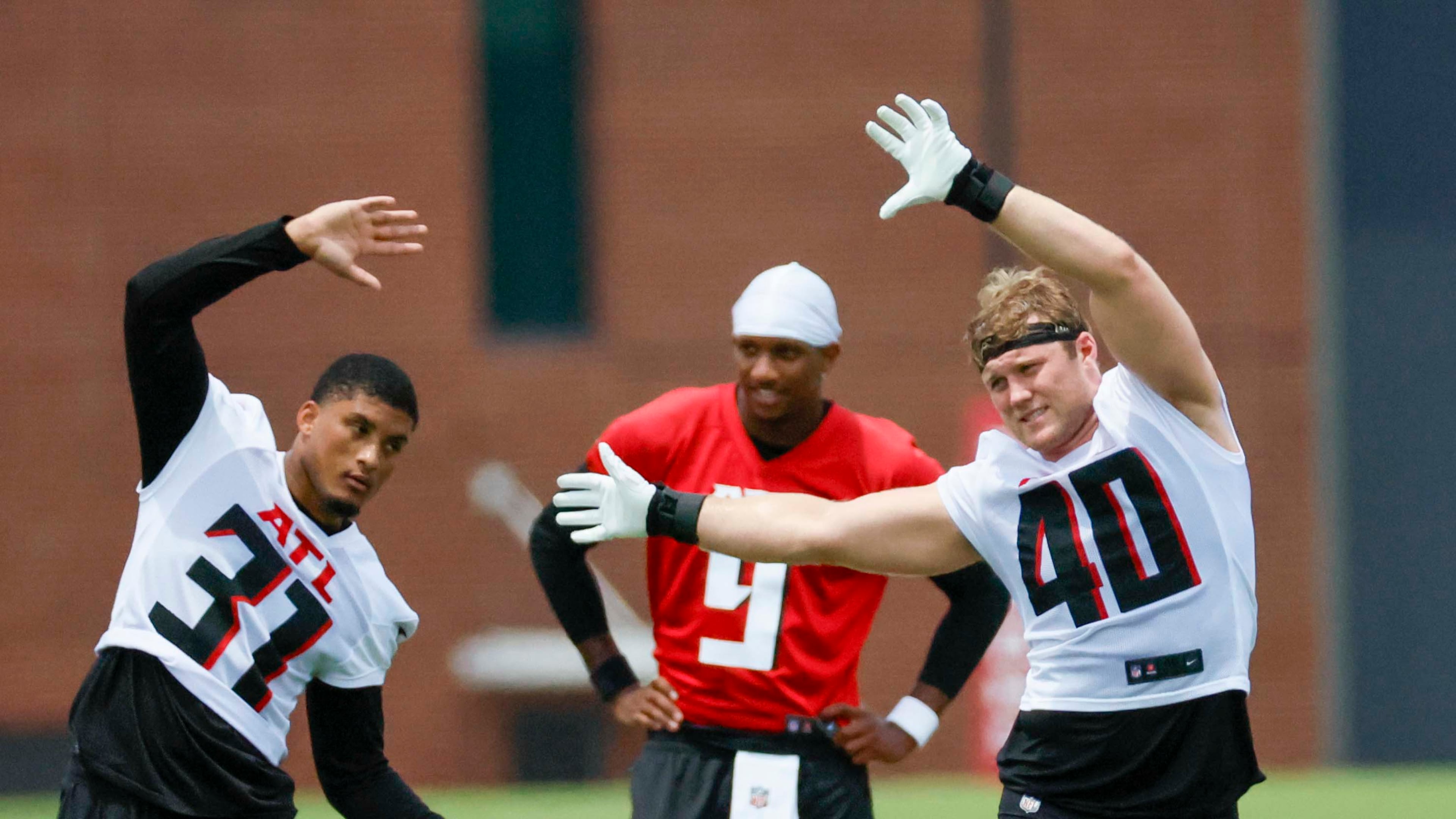 Atlanta Falcons linebacker JD Bertrand, right, and safety Xavier Watts stretch during minicamp at the Atlanta Falcons Training Facility, Wednesday, June 11, 2025, in Flowery Branch. Bertrand is expected to get more playing time with Divine Deablo out. (Miguel Martinez/AJC)