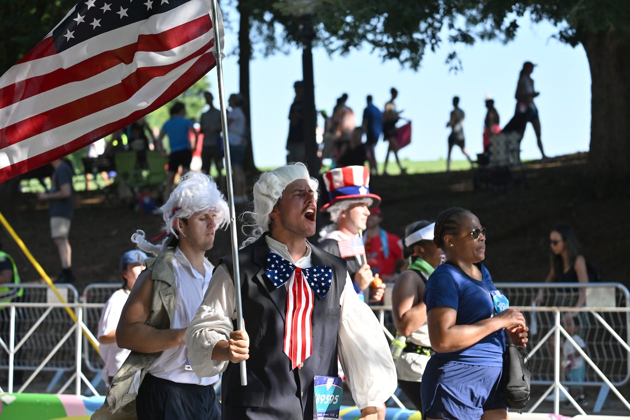 Patriotic runners cross the finish line at last year's Peachtree Road Race. (Hyosub Shin/AJC 2025)