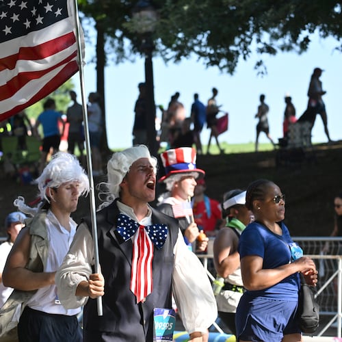 Patriotic runners cross the finish line at last year's Peachtree Road Race. (Hyosub Shin/AJC 2025)