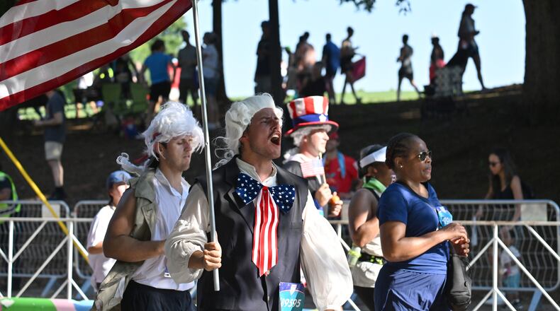 Patriotic runners cross the finish line at last year's Peachtree Road Race. (Hyosub Shin/AJC 2025)