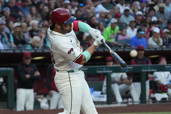 Arizona Diamondbacks' Eugenio Suárez hits a two-run home run against the Atlanta Braves in the fourth inning during a baseball game, Saturday, April 26, 2025, in Phoenix. (AP Photo/Rick Scuteri)