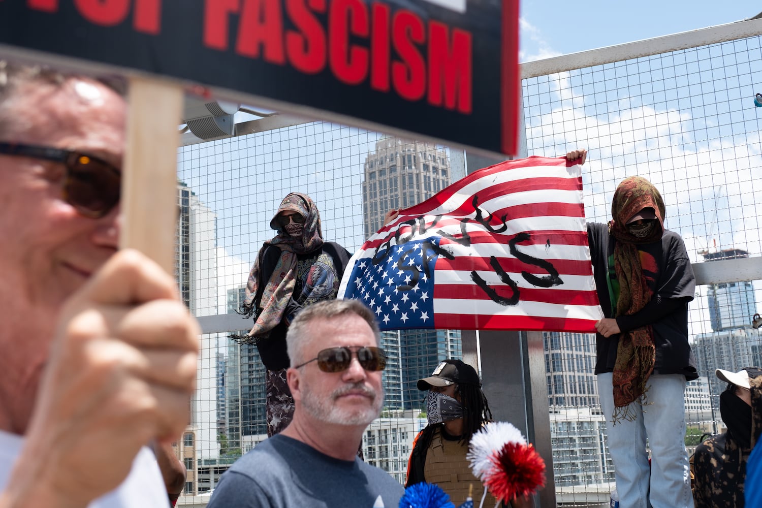 People gather on the 17th Street bridge  in Atlanta as part of the nation-wide No Kings protests Saturday, June 14, 2025.   Ben Gray for the Atlanta Journal-Constitution