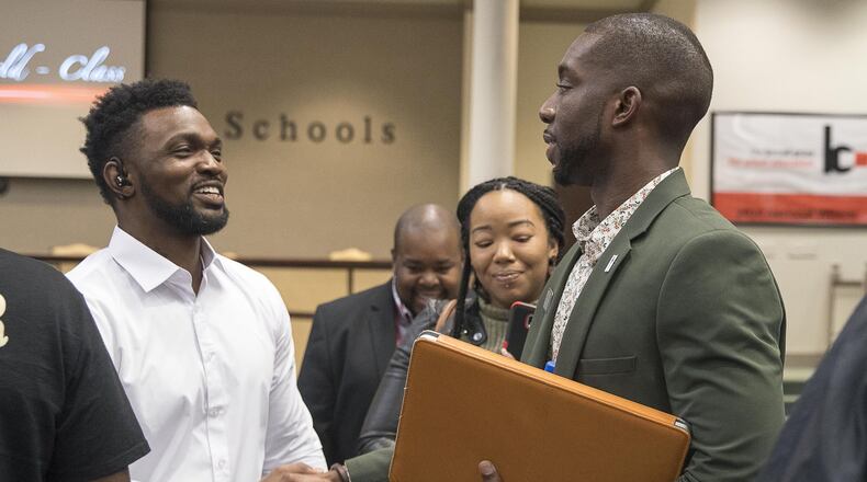 Gwinnett County school board member Everton Blair, Jr. (right) greets Tristan King (left), a father of two Gwinnett County Public School students, after a Gwinnett County School Board meeting in Suwannee, Thursday, March 21, 2019. On Feb. 28, King says his daughter, a kindergartner, was lost — left behind when the school bus took other kids home — at Norton Elementary. During the meeting he asked the board to fire the principal and others. ALYSSA POINTER/ALYSSA.POINTER@AJC.COM