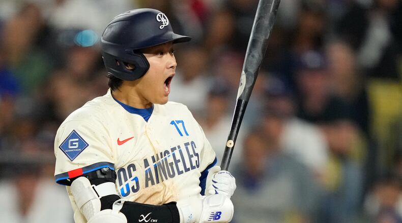 Los Angeles Dodgers' Shohei Ohtani reacts after a pitch was thrown in the dirt during the seventh inning of a baseball game against the Philadelphia Phillies, Saturday, May 30, 2026, in Los Angeles. (AP Photo/Mark J. Terrill)