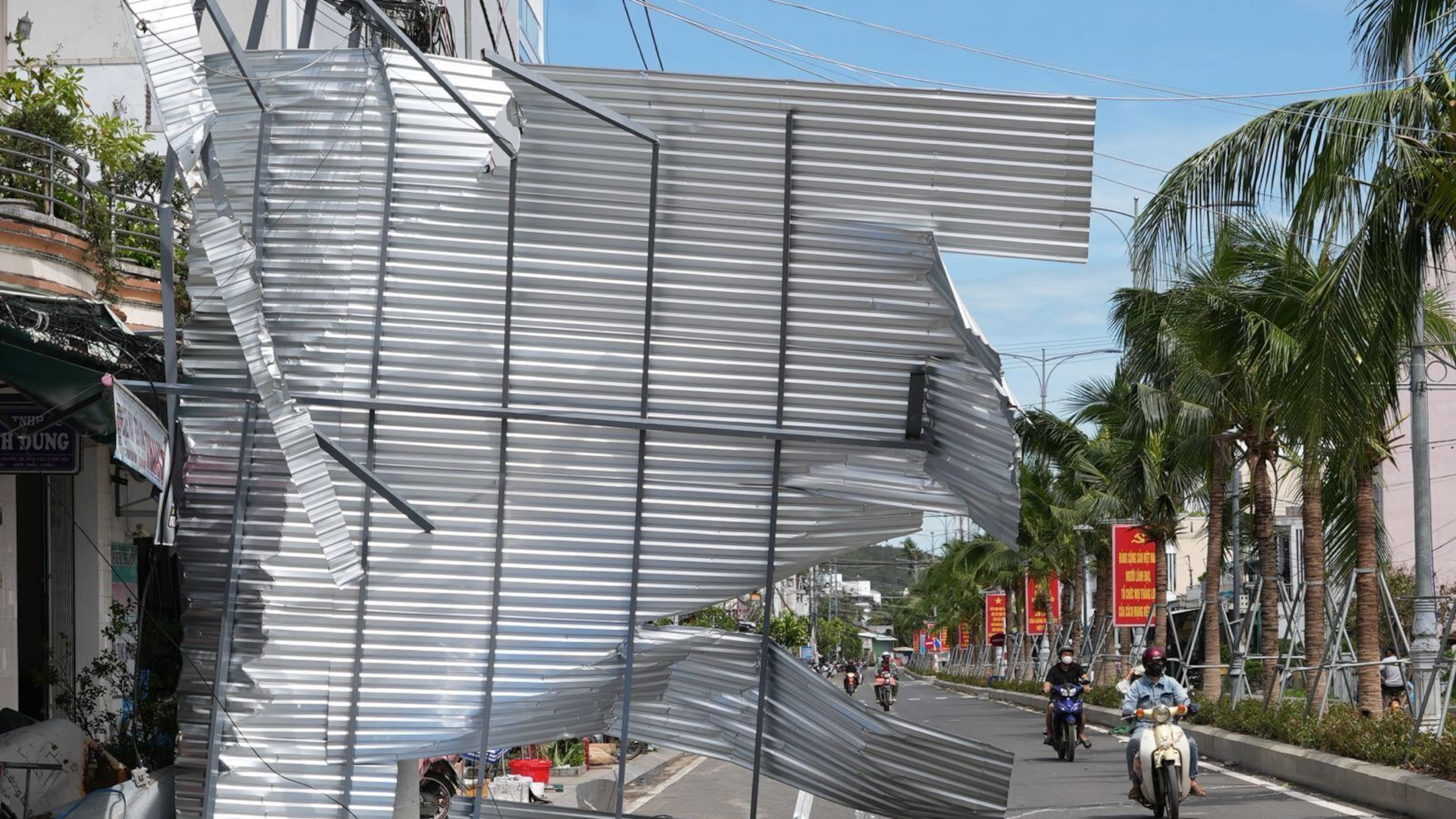A damaged building blocks a road in Dak Lak, Vietnam on Friday, Nov. 7, 2025 after Typhoon Kalmaegi lashed Vietnam with fierce winds and torrential rains. (AP Photo/Hau Dinh)