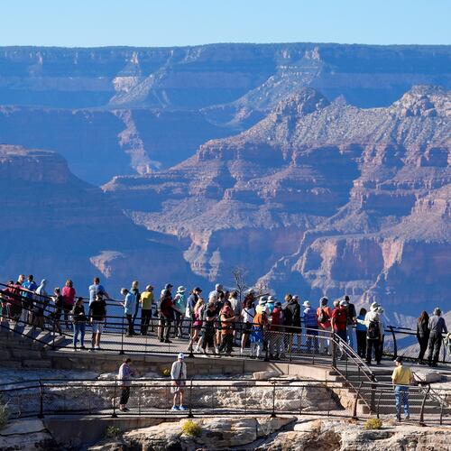FILE - Tourists flock to Mather Point at Grand Canyon National Park, Oct. 1, 2025, in Grand Canyon, Ariz. (AP Photo/Ross D. Franklin, File)