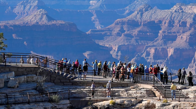 FILE - Tourists flock to Mather Point at Grand Canyon National Park, Oct. 1, 2025, in Grand Canyon, Ariz. (AP Photo/Ross D. Franklin, File)