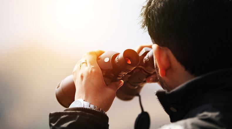 Young confident explorer looking through the nature.
