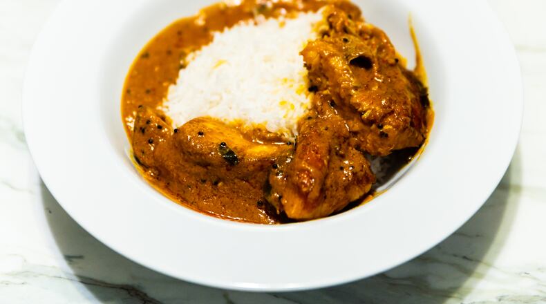 Blue India's red snapper moilee includes a curried red snapper filet nestled in a creamy coconut and coriander sauce, served with a side of basmati rice.