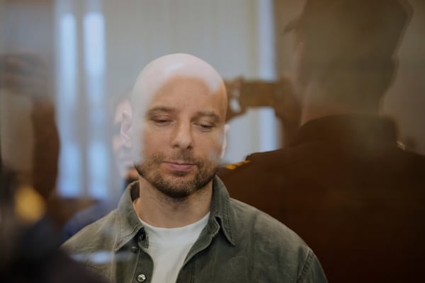 Russian journalist Sergey Karelin, accused of working for a group founded by the late Russian opposition politician Alexei Navalny, stands in a defendant's cage of the Nagatinsky District Court in Moscow, Russia, on Tuesday, April 15, 2025. (AP Photo)