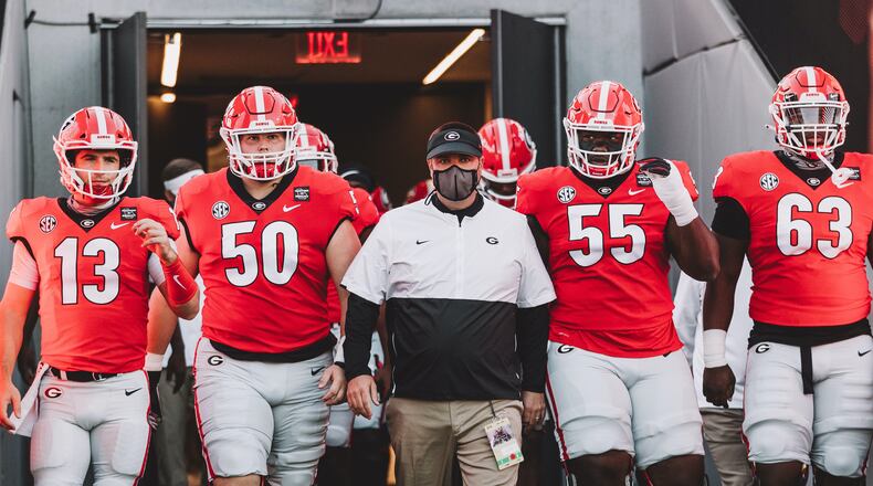 Georgia's director of football operations Josh Lee (center in mask) resigned on Monday amid an EOO investigation into his relationship with employees. (Photo from UGA Athletics)