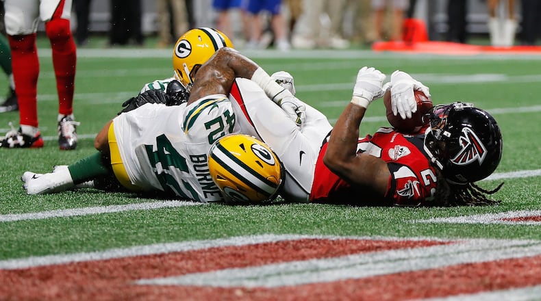 ATLANTA, GA - SEPTEMBER 17: Devonta Freeman #24 of the Atlanta Falcons scores a 1-yard rushing touchdown during the first quarter against the Green Bay Packers at Mercedes-Benz Stadium on September 17, 2017 in Atlanta, Georgia. (Photo by Kevin C. Cox/Getty Images)