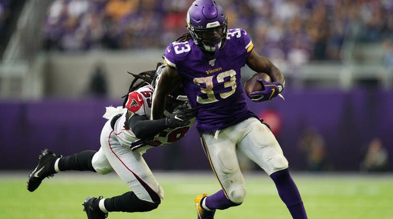 Dalvin Cook adds to the Vikings prodigious rushing total against Atlanta Sunday, eluding Falcons linebacker De'Vondre Campbell. (Anthony Souffle/Star Tribune/TNS)