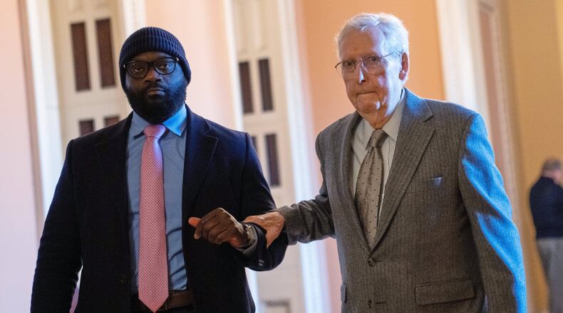 FILE - Sen. Mitch McConnell, R-Ky., right, walks through the Capitol, Jan. 15, 2026, in Washington. (AP Photo/Allison Robbert, File)