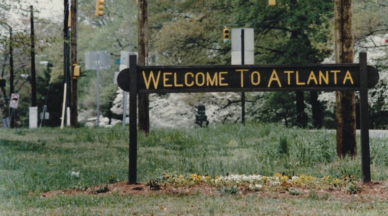 A rustic sign on Ponce de Leon Avenue at the city's edge read “Welcome to Atlanta” on one side and “Leaving Atlanta” on the other side. The sign stood at the edge of the Olmsted Linear Park next to a city-limits marker and might have been updated over the years. (Kimberly Smith/AJC Archive at GSU Library 1993)