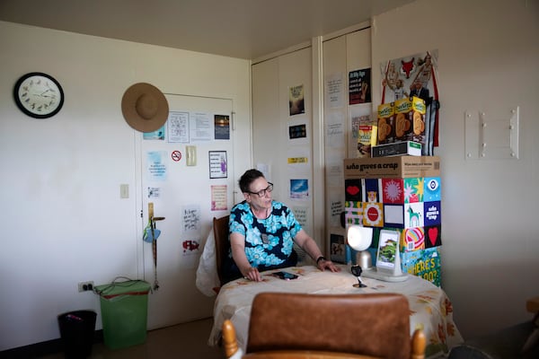 Monica Perez interacts with ElliQ, a voice-activated robotic companion powered by artificial intelligence, at her home in Beacon, N.Y., in 2024. The device is part of a New York state effort to ease the burdens of loneliness among older residents. (Lauren Lancaster/The New York Times)