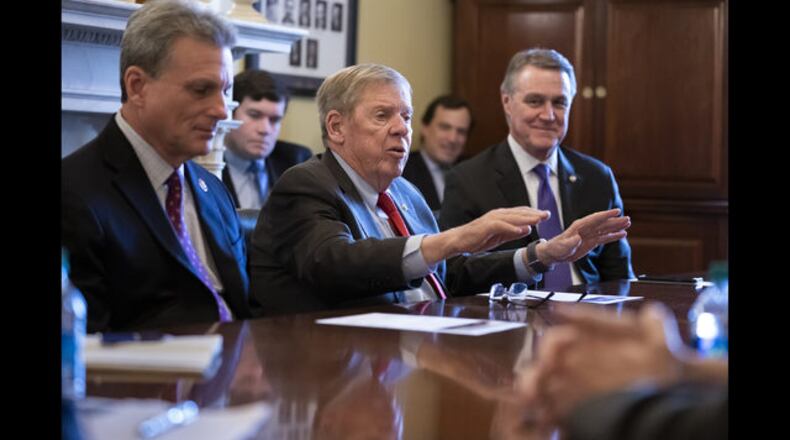 Sen. Johnny Isakson, R-Ga., flanked by Rep. Buddy Carter, R-Pooler, left, and Sen. David Perdue, R-Ga., right, in a meeting on Feb. 14, 2019. (AP Photo/J. Scott Applewhite, File) </p>