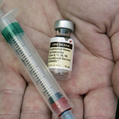 FILE - A doctor holds a vial of the human papillomavirus (HPV) vaccine Gardasil in Chicago on Aug. 28, 2006. (AP Photo/Charles Rex Arbogast, File)