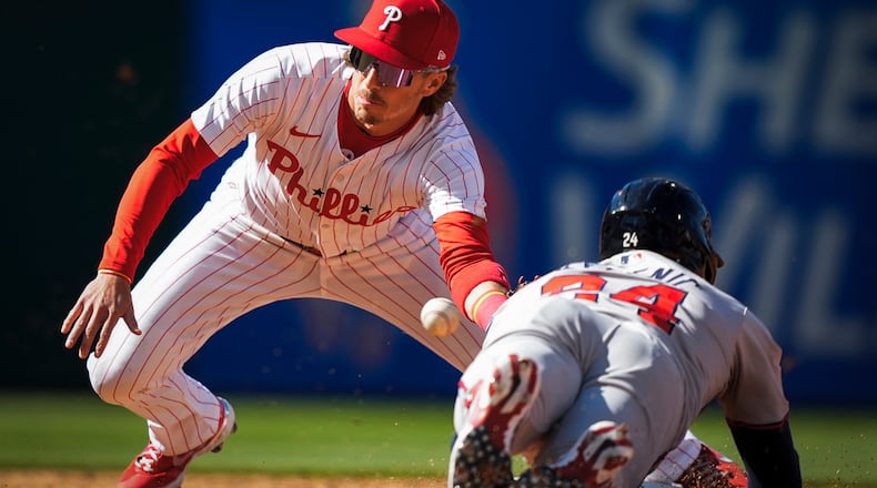 Philadelphia Phillies' Bryson Stott tags out Atlanta Braves' Jarred Kelenic attempting steal second during the third inning of an opening day baseball game, Friday, March 29, 2024, in Philadelphia. (AP Photo/Matt Slocum)
