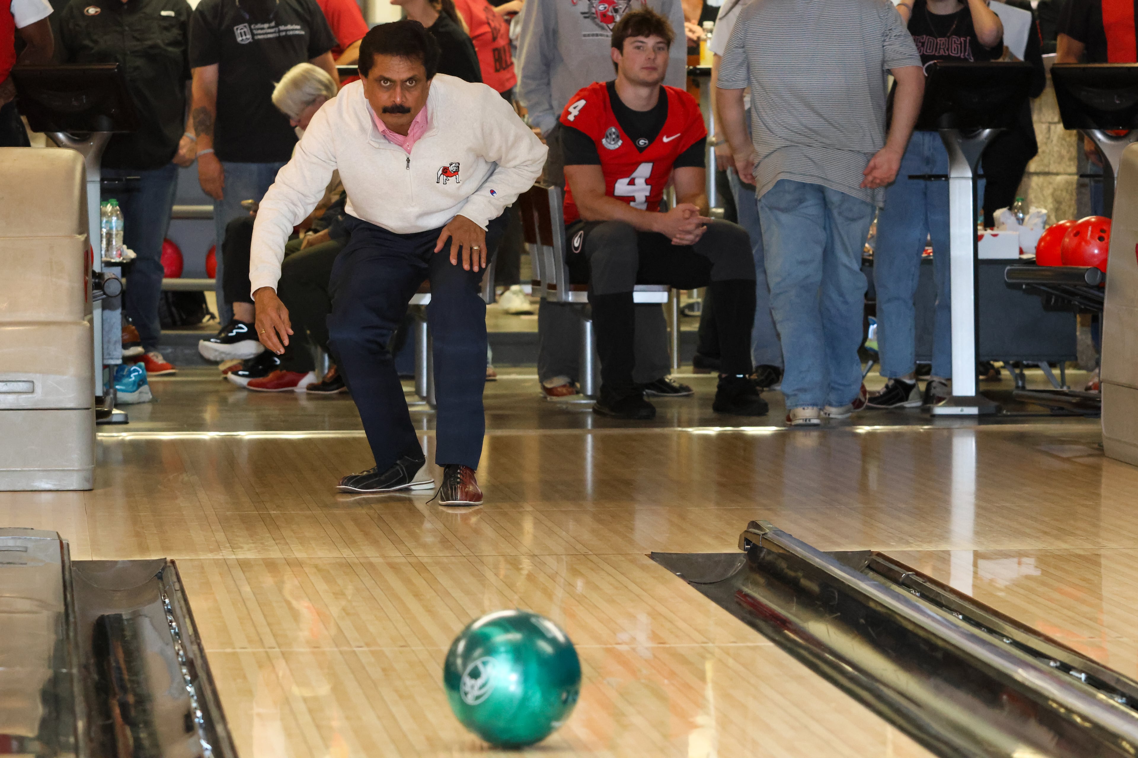 Dr. Anumantha Kanthasamy, UGA professor of physiology and pharmacology and director of the Isakson Center for Neurological Disease Research, bowls during the third annual Chick-fil-A Dawg Bowl fundraiser at Showtime Bowl in Athens on Wednesday, Oct. 22, 2025. The Dawg Bowl has raised more than $2 million in the past three years for the Isakson Center’s research into Parkinson’s and Crohn’s diseases. (C.J. Bartunek for the AJC)
