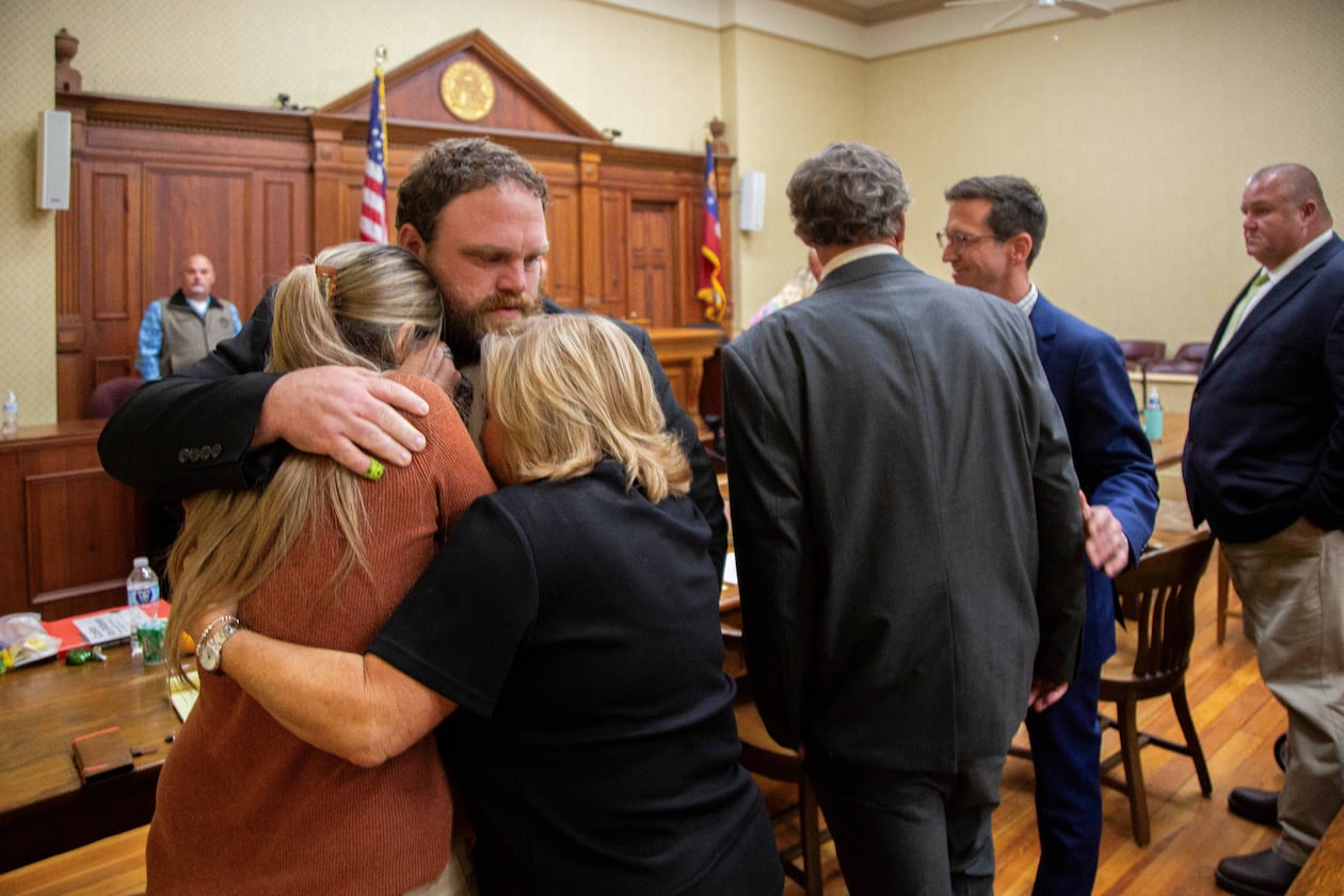 Rhett Scott hugs his wife, Kelly Scott (left), and his mother, Karen Scott, after being found not guilty of felony murder and other charges in the 2017 death of Eurie Martin on Thursday, Nov. 20, 2025, at the trial in Sandersville. (Grant Blankenship/Georgia Public Broadcasting via AP)