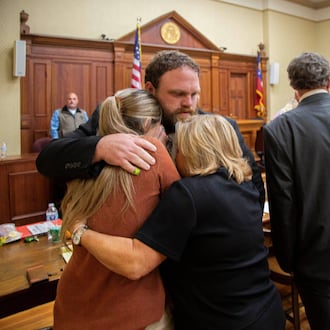 Rhett Scott hugs his wife, Kelly Scott (left), and his mother, Karen Scott, after being found not guilty of felony murder and other charges in the 2017 death of Eurie Martin on Thursday, Nov. 20, 2025, at the trial in Sandersville. (Grant Blankenship/Georgia Public Broadcasting via AP)