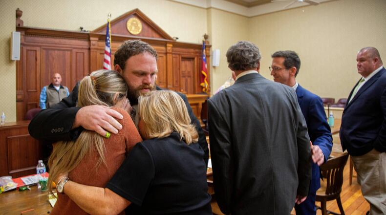 Rhett Scott hugs his wife Kelly Scott, left, and his mother Karen Scott, right, after being found not guilty of felony murder in the 2017 death of Eurie Martin on Thursday, Nov. 20, 2025 in Sandersville, Ga. (Grant Blankenship/Georgia Public Broadcasting via AP)