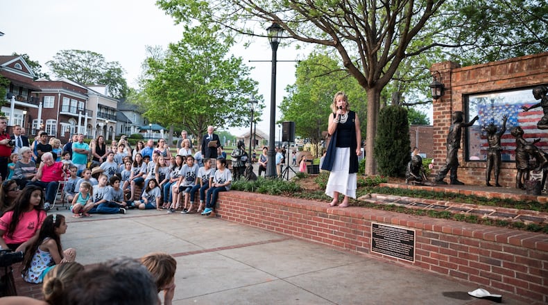 Duluth resident, artist and sculptor Kathy Fincher discusses The Dream Keepers monument at the Duluth Town Green. (Courtesy Ciity of Duluth)