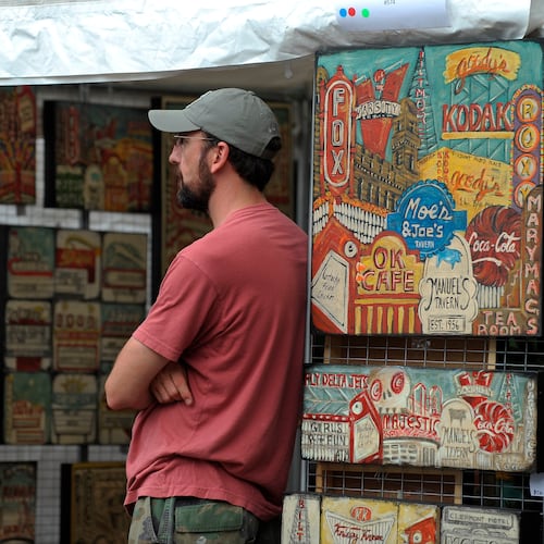 Will Coil of Smyrna keeps watch over wife Maria Louise Coil's local landmark art at the Virginia-Highland Summerfest. (Courtesy of David Tulis)