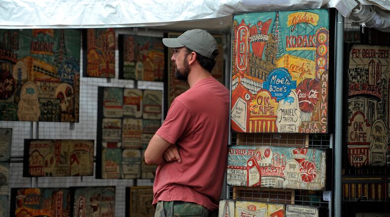 Will Coil of Smyrna keeps watch over wife Maria Louise Coil's local landmark art at the Virginia-Highland Summerfest. (Courtesy of David Tulis)