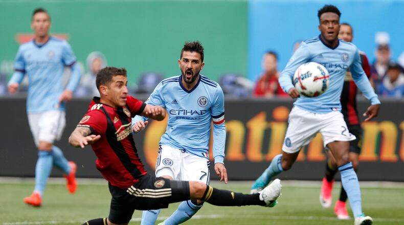 Atlanta United midfielder Carlos Carmona, left, of Chile defends New York City FC forward David Villa (7) of Spain center as New York City FC Rodney Wallace watches, right, during the first half of an MLS soccer game, Sunday, May 7, 2017, in New York. (AP Photo/Kathy Willens)