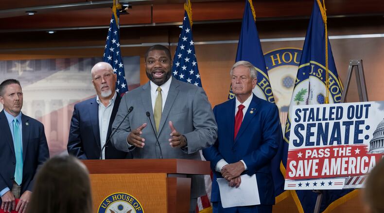 Rep. Byron Donalds, R-Fla., center, flanked by Rep. Chip Roy, R-Texas, left, and Rep. Ralph Norman, R-S.C., right, speaks to reporters as the conservative House Freedom Caucus slams the Senate for not acting on the Save America Act at the Capitol in Washington, Thursday, June 25, 2026. (AP Photo/J. Scott Applewhite)