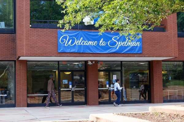 People walk past a sign that says “Welcome to Spelman” on move-in day at Spelman College in Atlanta on Aug. 12, 2026. (Arvin Temkar/AJC)