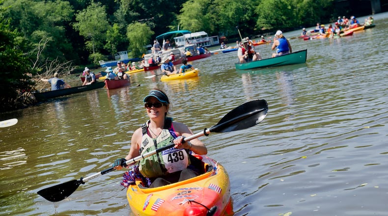 Kim West (left) paddles to the boat take out on the Chattahoochee River in Roswell on Saturday, June 15, 2013. JONATHAN PHILLIPS / SPECIAL