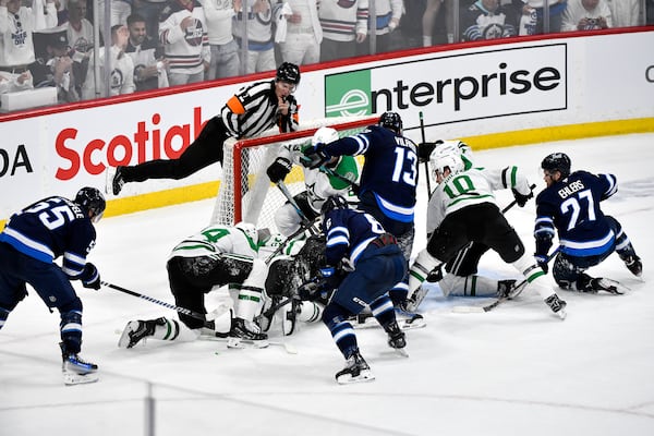 Winnipeg Jets players crowd the net around Dallas Stars goaltender Jake Oettinger trying to score in the last minutes of the third period NHL playoff hockey action in Winnipeg, Canada, Wednesday, May 7, 2025. (Fred Greenslade/The Canadian Press via AP)