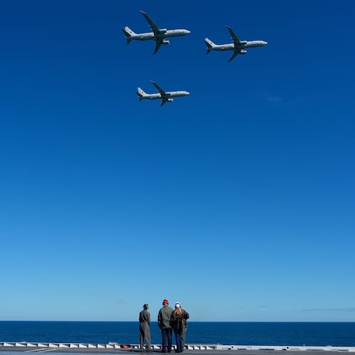 President Donald Trump and first lady Melania Trump watch a flight of P-8A Poseidon aircraft during a naval sea power demonstration, part of the Navy's 250th anniversary celebration, aboard the USS George H.W. Bush aircraft carrier in the Atlantic Ocean off the coast of Norfolk, Va., Sunday, Oct. 5, 2025. (AP Photo/Alex Brandon)