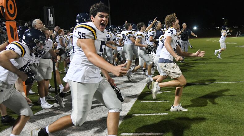 Time to celebrate: The Marist sideline celebrates after Friday's 28-13 victory over Blessed Trinity.