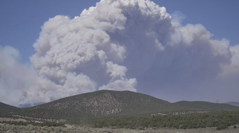 A plume of smoke rises from the Cottonwood Fire, Friday, June 26, 2026, near Beaver, Utah. (AP Photo/Ty ONeil)