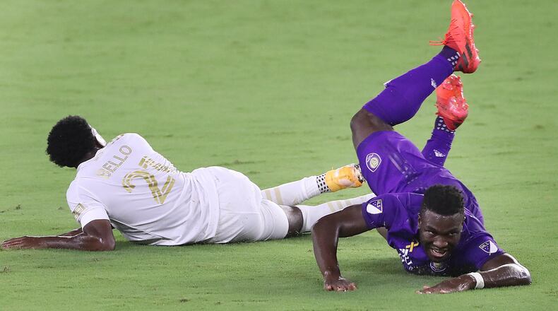 Orlando City's Daryl Dike, right, falls over Atlanta United's George Bello (21) at Exploria Stadium in Orlando, Florida, on Saturday, Sept. 5, 2020. (Stephen M. Dowell/Orlando Sentinel/TNS)