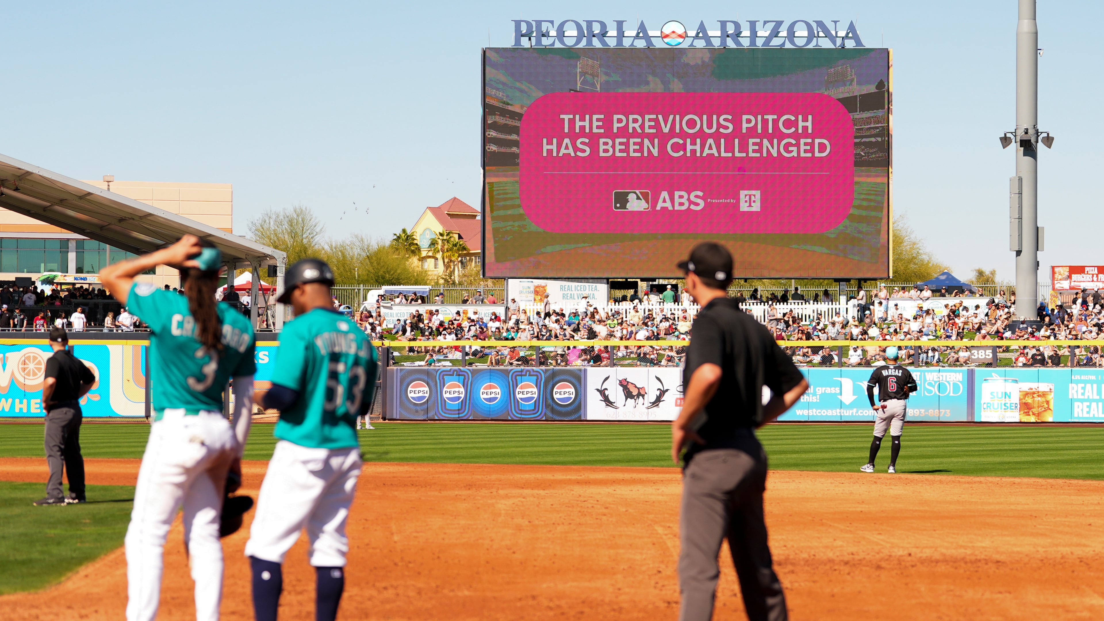 FILE - An outfield screen shows a graphic indicating Seattle Mariners' Julio Rodriguez challenged a pitch call, initiating a review with the automated ball-strike challenge system, in the third inning against the Arizona Diamondbacks during a spring training baseball game Sunday, Feb. 23, 2025, in Peoria, Ariz. (AP Photo/Lindsey Wasson, file)