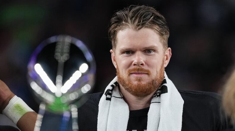 Seattle Seahawks quarterback Sam Darnold eyes the Lombardi Trophy after a win over the New England Patriots in the NFL Super Bowl 60 football game Sunday, Feb. 8, 2026, in Santa Clara, Calif. (AP Photo/Matt Slocum)