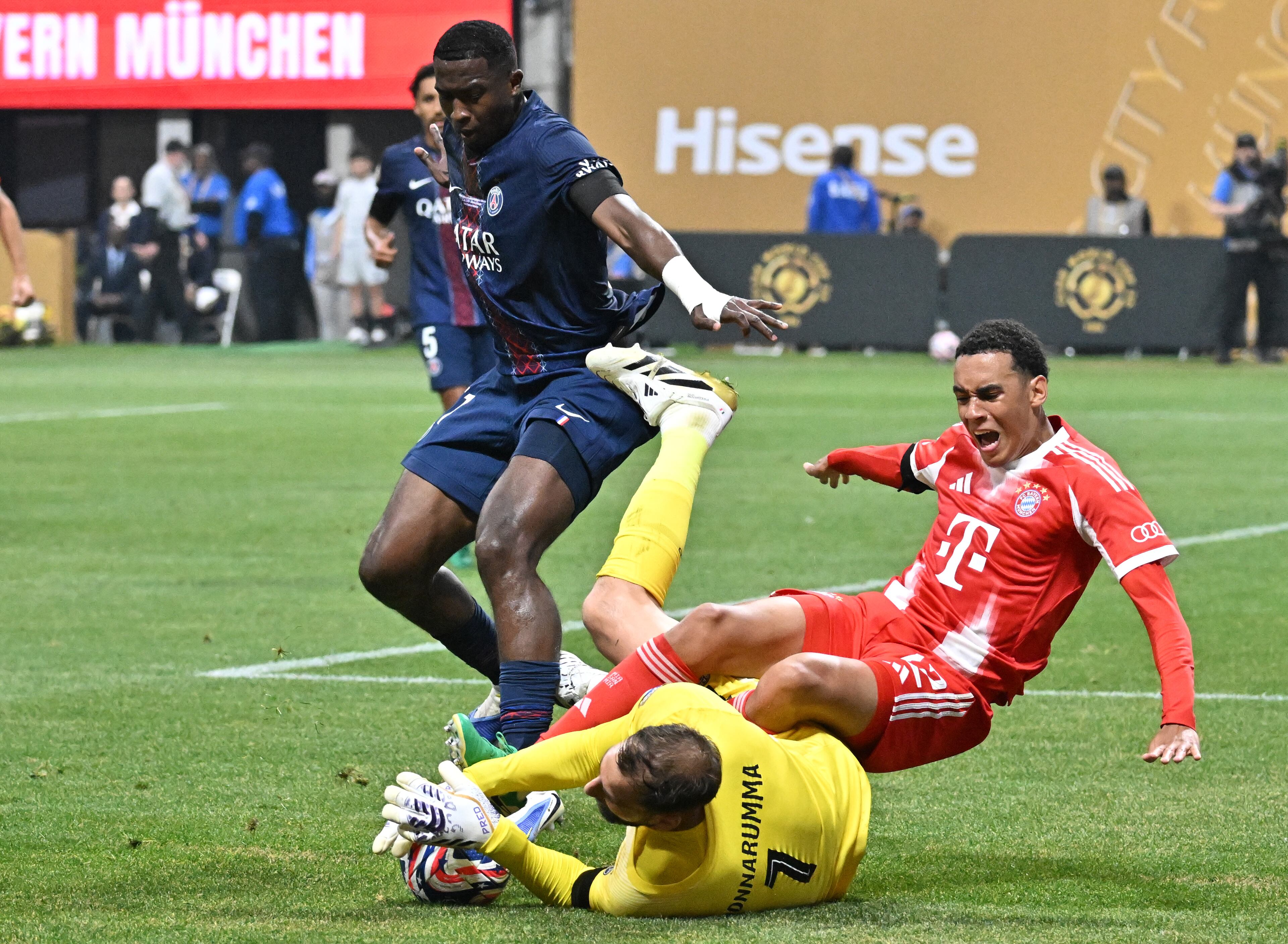 Paris Saint-Germain goalkeeper Gianluigi Donnarumma (ground) blocks a shot by Bayern Munich midfielder Jamal Musiala (right) during the first half of the Club World Cup quarterfinals match at Mercedes-Benz Stadium on Saturday, July 5, 2025, in Atlanta. (Hyosub Shin/AJC)
