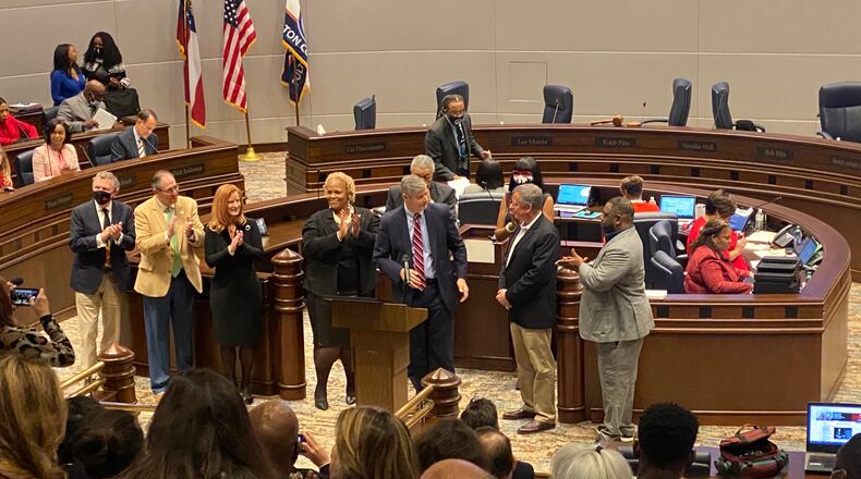 Mike Bodker of Johns Creek (tan suit second from the left) and Joe Lockwood (navy suit second from the right) of Milton are the only mayors either city has ever known since incorporating Dec. 1, 2016. (Ben Brasch/AJC)