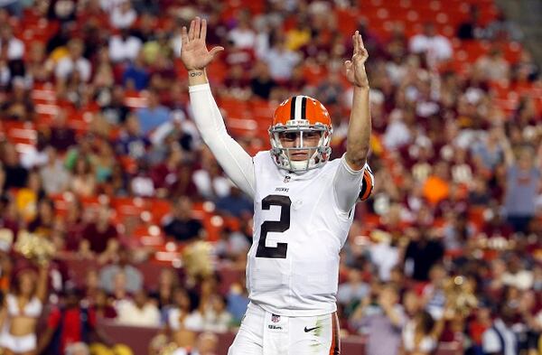 Cleveland Browns quarterback Johnny Manziel (2) celebrates running back Dion Lewis (28) scoring a touchdown on a pass, during the second half of an NFL preseason football game against the Washington Redskins Monday, Aug. 18, 2014, in Landover, Md. (AP Photo/Evan Vucci) This sort of gesture is A-OK. (Evan Vucci/AP)