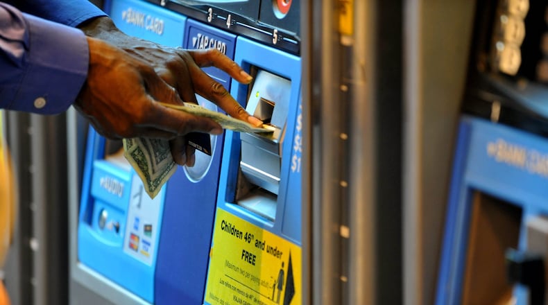 Patrons using fare machines at the Hartsfield Jackson International Airport MARTA station. KENT D. JOHNSON AJC File Photo